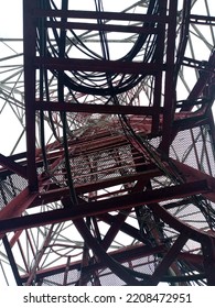 Microwave Radio Communication Tower That Towers To The Red And White Sky.