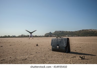 Mid Adult Businessman Doing Cartwheel On Beach