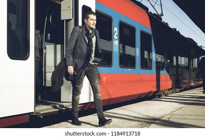 Mid Adult Businessman Getting To Work By Train And Arriving On Railway Station. 