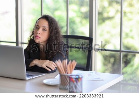 Mid adult businesswoman touching got headache while looking away in office after bad news business failure or get fired and feeling discouraged, distraught and hopeless in modern office. 