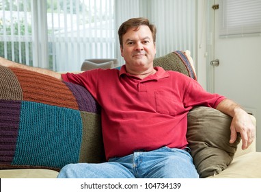 Mid Adult Caucasian Man Relaxing At Home On The Couch.