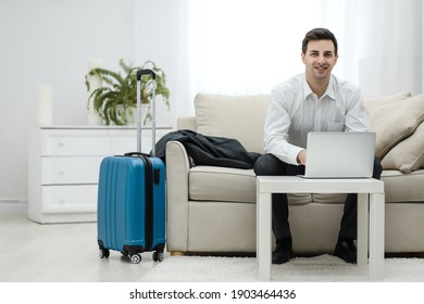 Mid Adult Caucasian Manager Typing On Laptop In Hotel Room During Business Travel.