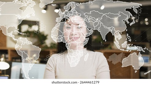 Mid adult Chinese woman wearing beige top analyzing data in modern office, with digital world map. Corporate, technology, professional, analytical, workspace, sleek, innovative