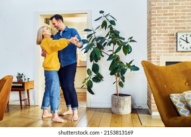 Mid Adult Couple Having Fun Dancing Together At Home