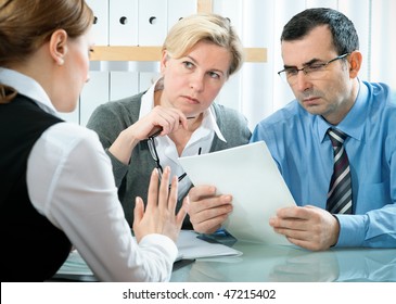 Mid Adult Couple Meeting With Agent Or Advisor