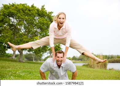 mid adult couple playing leapfrog