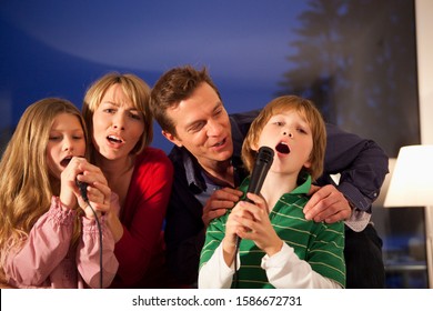 Mid Adult Family Singing Karaoke At Home