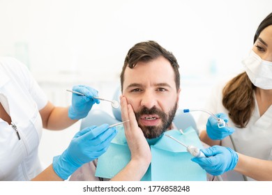 Mid Adult Hispanic Man Suffering From Toothache And Visiting A Dental Clinic