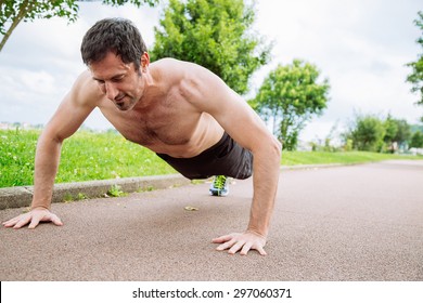 Mid Adult Man Doing Pushups Outdoors Shirtless