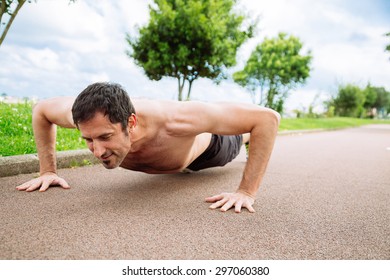 Mid Adult Man Doing Pushups Outdoors Shirtless