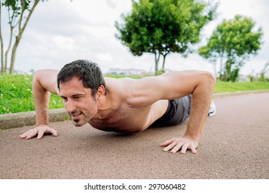 Mid Adult Man Doing Pushups Outdoors Shirtless