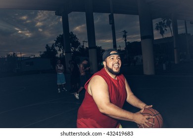 Mid Adult Man Wearing Vest Playing Basketball Open Mouthed Smiling