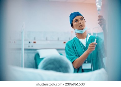 Mid adult nurse taking care of a patient at intensive care unit who is recovering in the hospital. Copy space. - Powered by Shutterstock