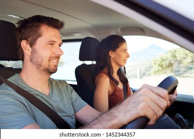 Mid Adult White Man Driving Car, His Wife Beside Him In Front Passenger Seat, Close Up, Side View