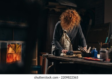 Mid Adult Woman Craftsman Working With Pottery In Her Work Shop