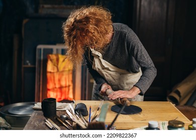 Mid Adult Woman Craftsman Working With Pottery In Her Work Shop