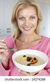 Mid Adult Woman Eating Porridge With Fresh Fruit