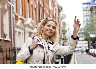 A Mid Adult Woman Hailing A Taxi