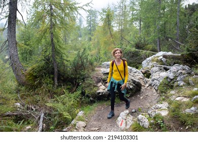 Mid Adult Woman Hiking Alone In Mountains