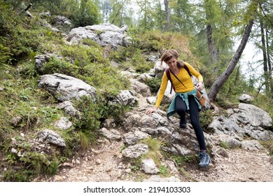 Mid Adult Woman Hiking Alone In Mountains