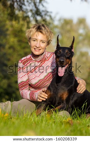 Similar – Pretty blond woman with her two dogs