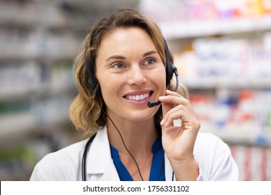 Mid adult woman pharmacist talking to client in a pharmaceutical call center. Medical worker taking home delivery order of medicine by phone. Doctor consulting and help in service customer support.