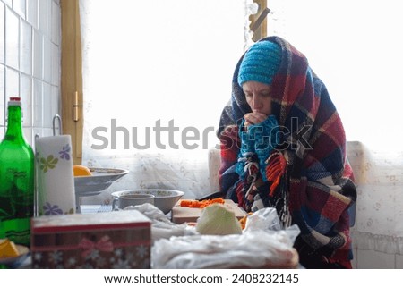 Mid Adult Woman Preparing herself a Poor Meal in an Old Cold Apartment - Poverty Social Issues