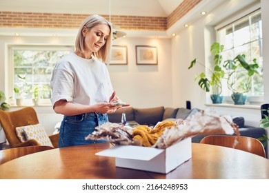 Mid adult woman preparing return of online order - Powered by Shutterstock