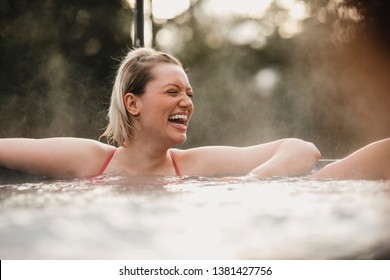 Mid Adult Woman Relaxing In A Hot Tub With Her Friends.