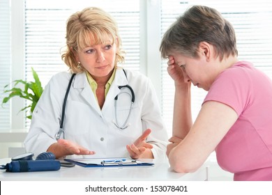 Mid adult woman talking to doctor about her diagnosis