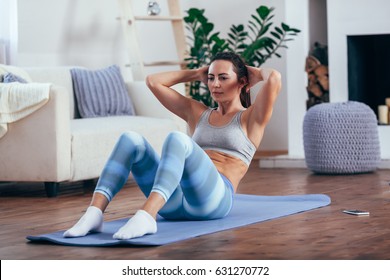 Mid Adult Woman Training Abdominals At Home