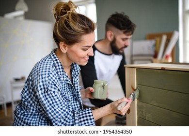 Mid adults couple painting furniture indoors at home, relocation and diy concept. - Powered by Shutterstock