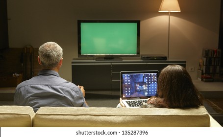 Mid Adults Watching TV And PC Thanks To Internet Possibilities