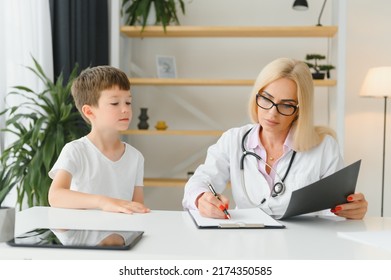 Mid Age Female Doctor Writing Prescription.