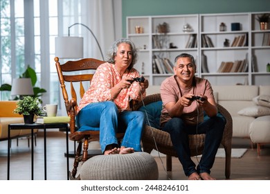 Mid age Indian couple having fun playing video games - Powered by Shutterstock