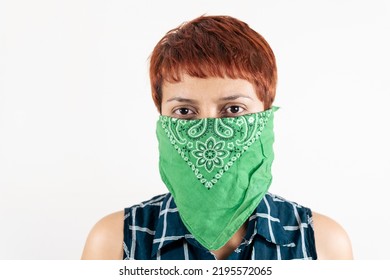 A Mid Age Latin Woman Covers Her Face With A Scarf