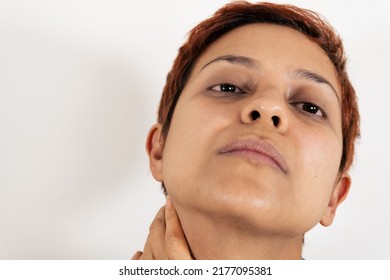 A Mid Age Latin Woman With Her Head Tilted Back