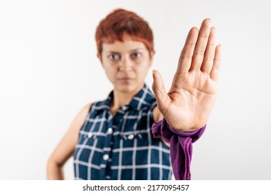 A Mid Age Latin Woman Shows Her Left Hand In A Stop Sign