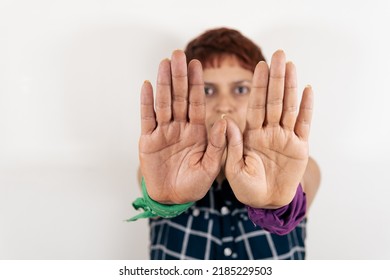 A Mid Age Latin Woman Shows Her Hands In A Stop Sign