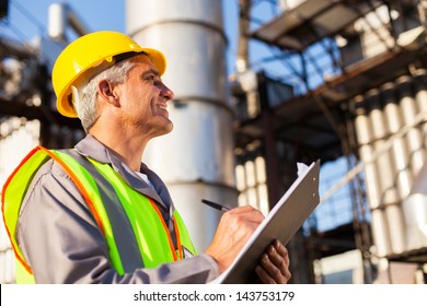 Mid Age Petroleum Factory Worker Working Outdoors