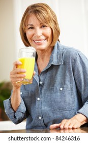 Mid Age Woman Drinking Orange Juice