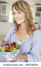 Mid Age Woman Eating Salad