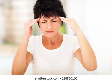 Mid Age Woman Having Headache And Massaging Forehead