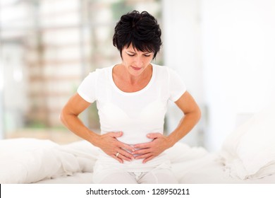 Mid Age Woman Having Stomach Pain At Home