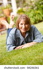 Mid Age Woman Relaxing In Garden