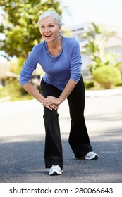 Mid Age Woman Warming Up For Run