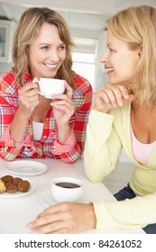 Mid Age Women Chatting Over Coffee At Home