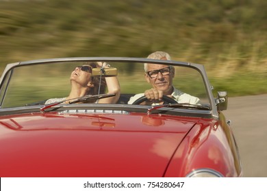 Mid Aged Couple In Sports Car