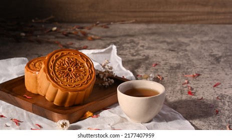 Mid Autumn Festival Mooncake And And Green Tea On Stone Table