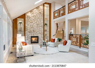 Mid Century Craftsman House Interior Living Room Foyer Home Office With Wood Panel Walls Staircase Creative Wooden Railings Stone Fireplace In Warm White Tones And Orange Accent Colors